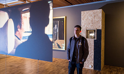 Man looking at artwork in gallery
