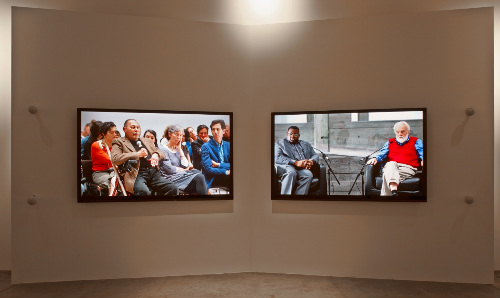 Wall installation with two flat screen tvs showing a film