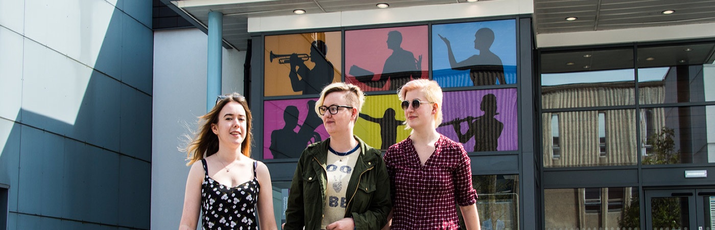 Three female students outside The Martin Harris centre