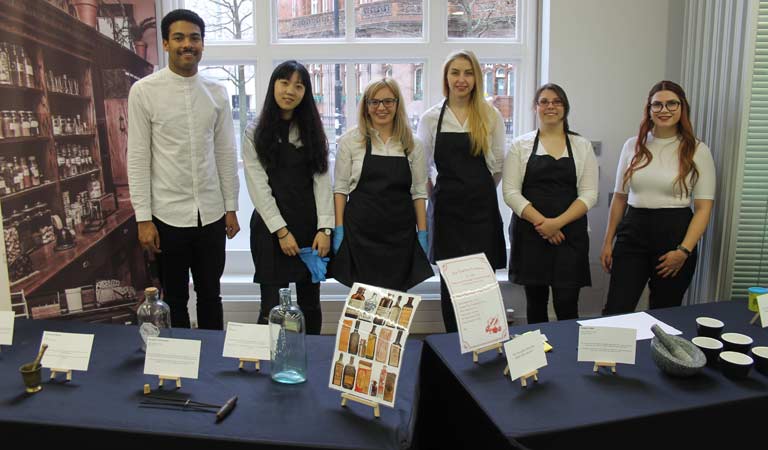 Students with pharmacy exhibitions which included a pestle and mortar, medicine bottles and an antique set of forceps.