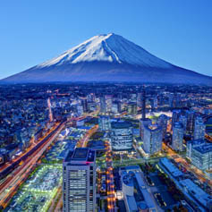 Mount Fuji looming over urban sprawl of Japanese city