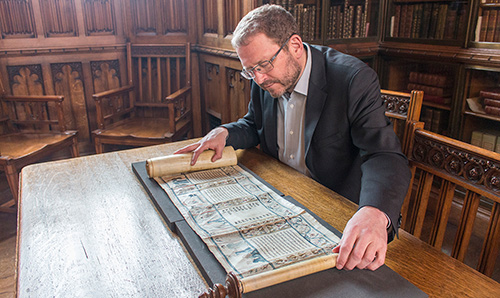 Researcher examining scroll