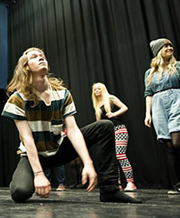 Drama students rehearsing on stage.