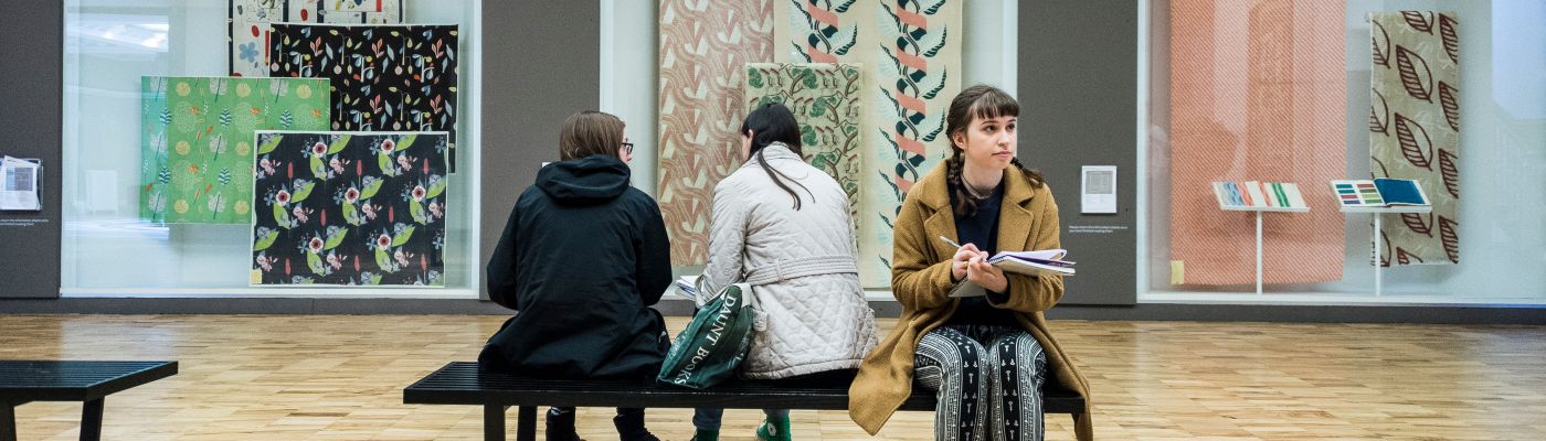 A female student sat in the Whitworth Art Gallery.