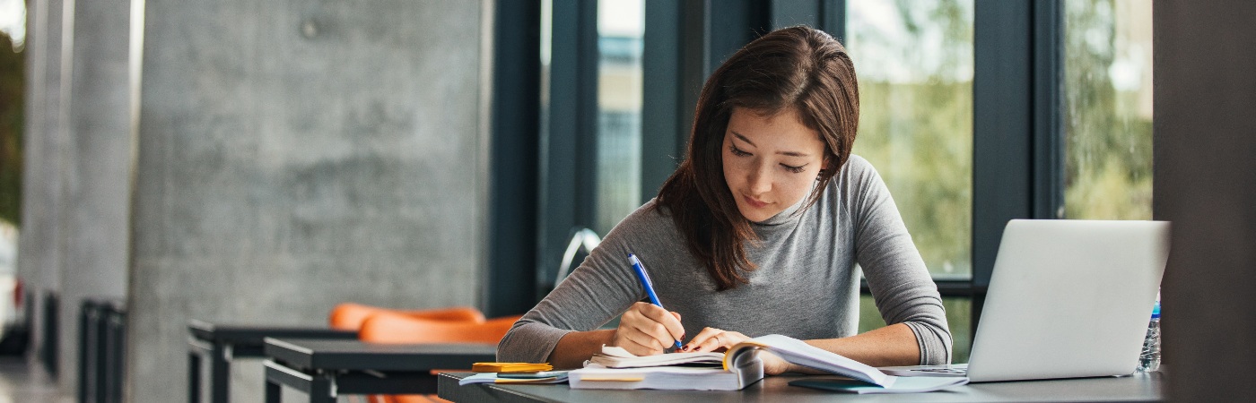 Female student on laptop in library