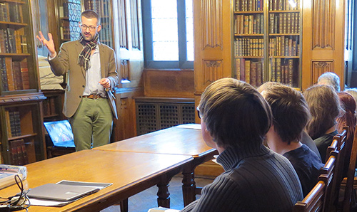 Male teaching speaking to students