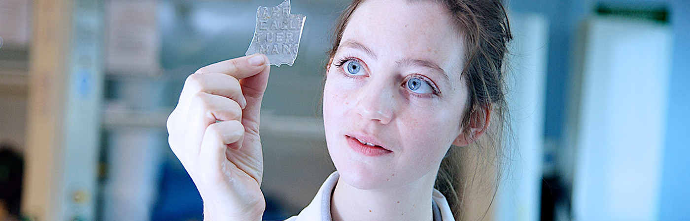 Female student looking at glass