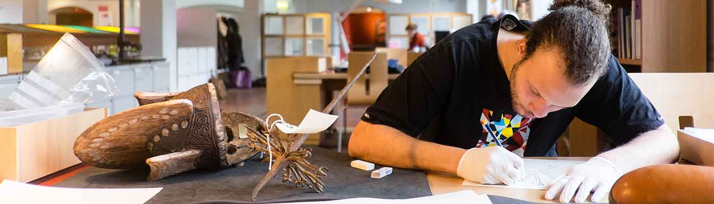 Student working on archaeological drawings