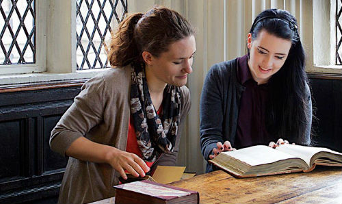 Students looking at books in Cheetham Library