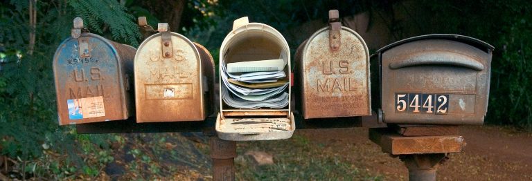 Five rusty American-style post boxes