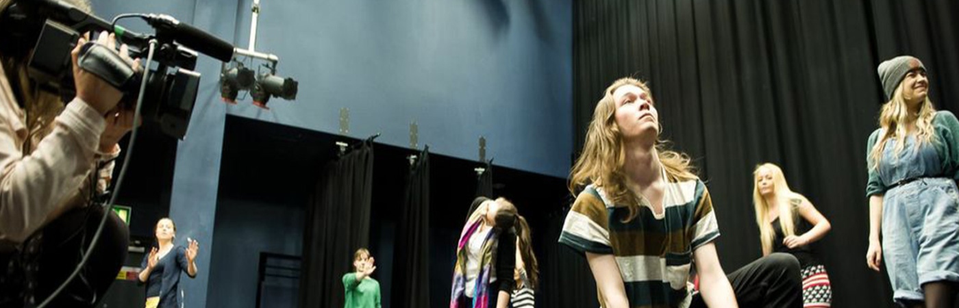 Students being filmed on stage