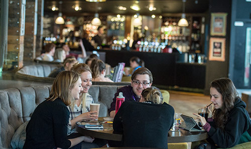 Students sat around table in student union