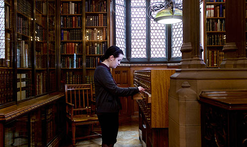 Female student looking through library records