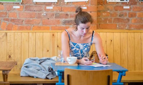 Woman in cafe looking at phone.