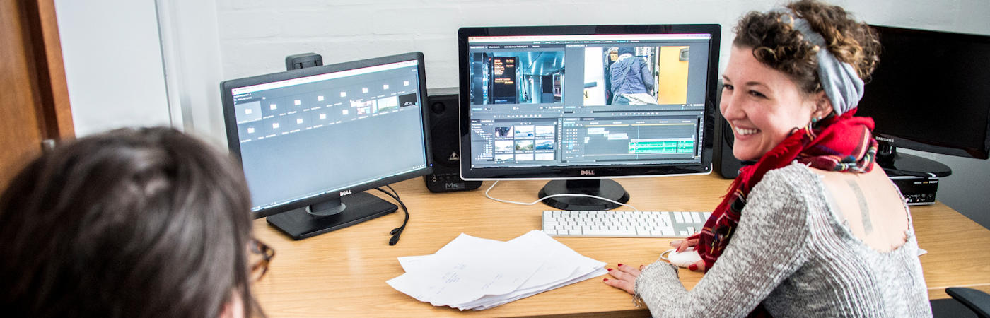 Two students in media editing suite.