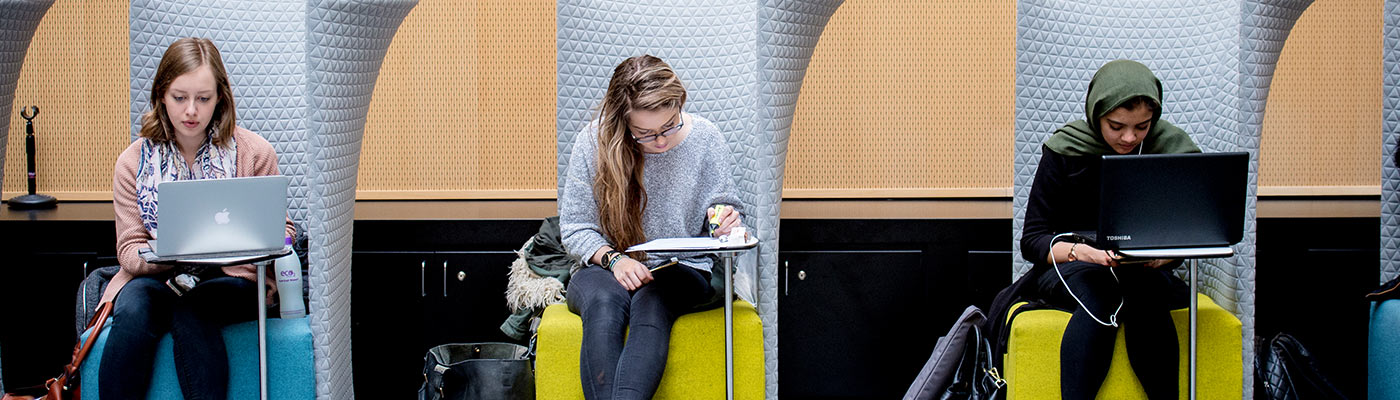 Three students working in University Place Atrium