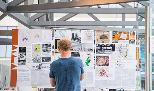 Man in front of display board