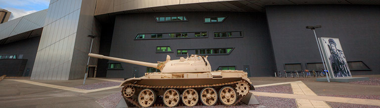 World War 2 tank parked outside of a modern day museum