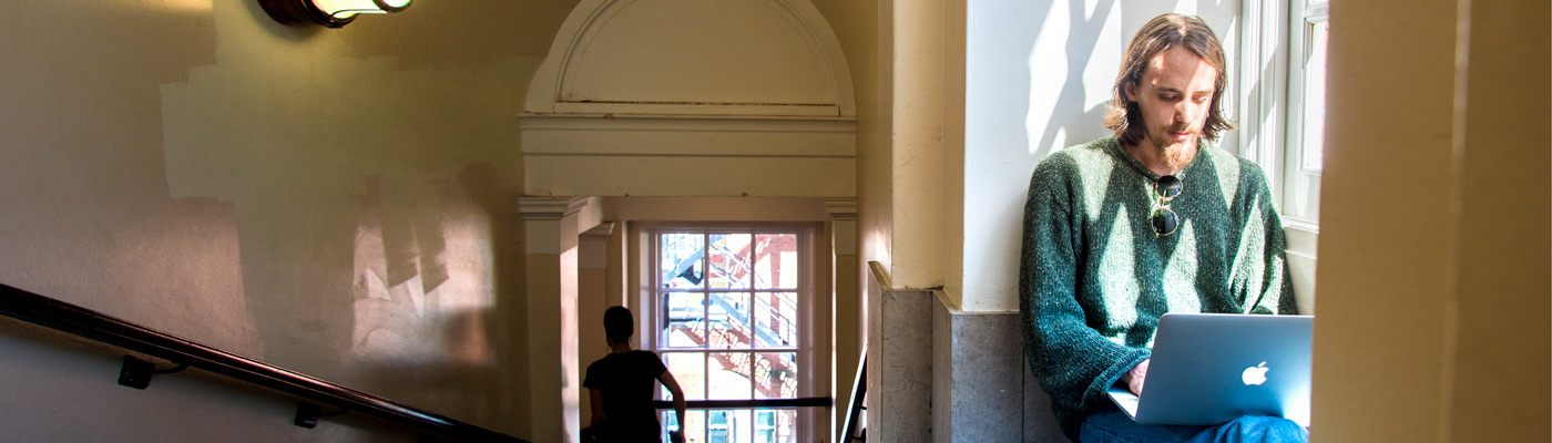 Student using laptop in the Samuel Alexander Building