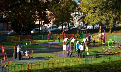 A diverse group of parents and children at a play park