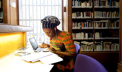 Woman working at desk in library