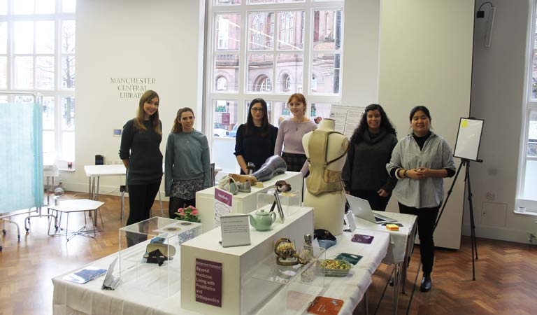 Photograph of four of our students providing some historical context for a selection of prosthetic and orthopaedic exhibits.