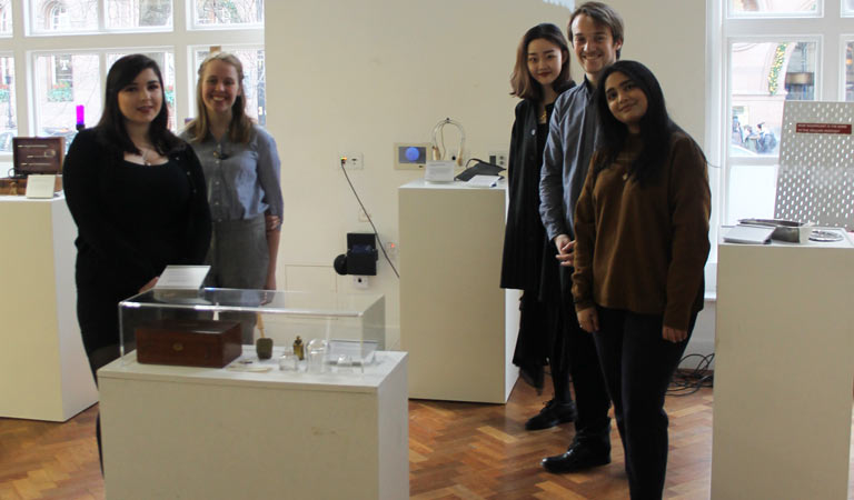 Five students with some of the day's exhibits.