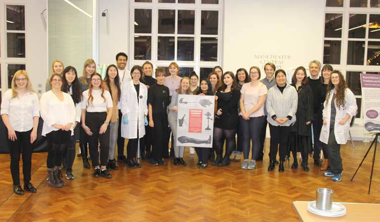 The students behind the exhibition pose for a photograph at Manchester's Central Library.