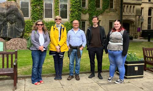 A group of people standing outside the university