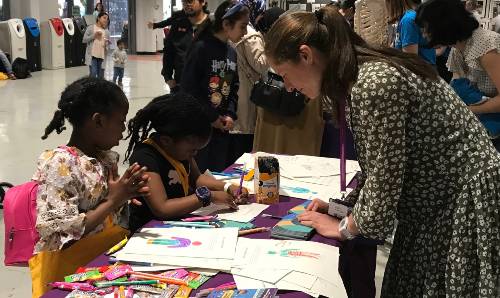 Female and children drawing pictures