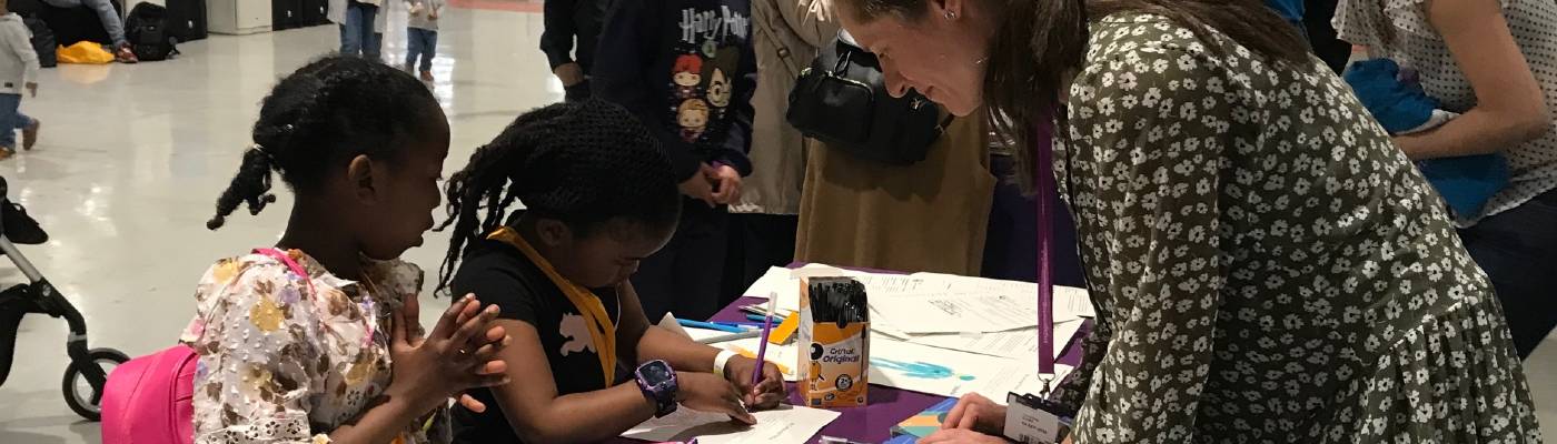 Female and children drawing pictures