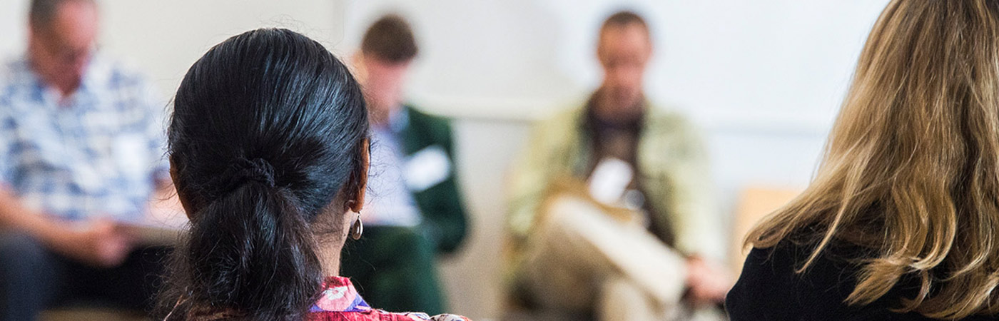 Back of woman's head sitting in a talk