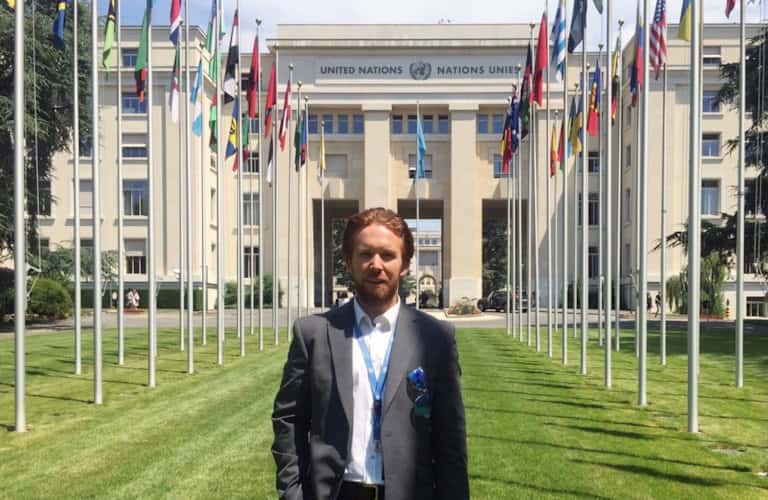 Steven in front of the Palais des Nations in Geneva, Switzerland