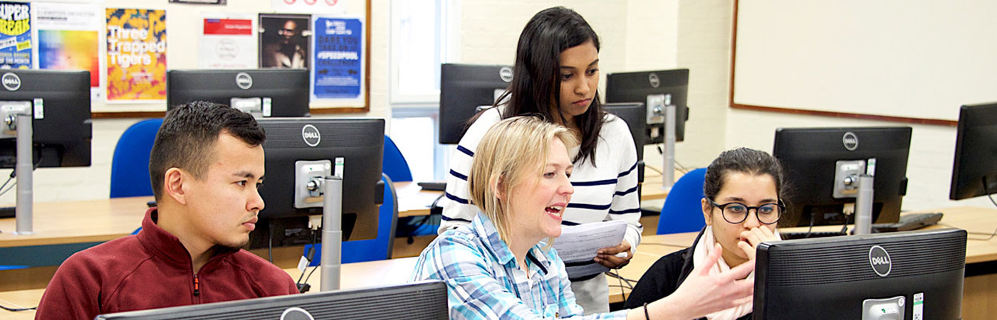 Female teaching students at a computer