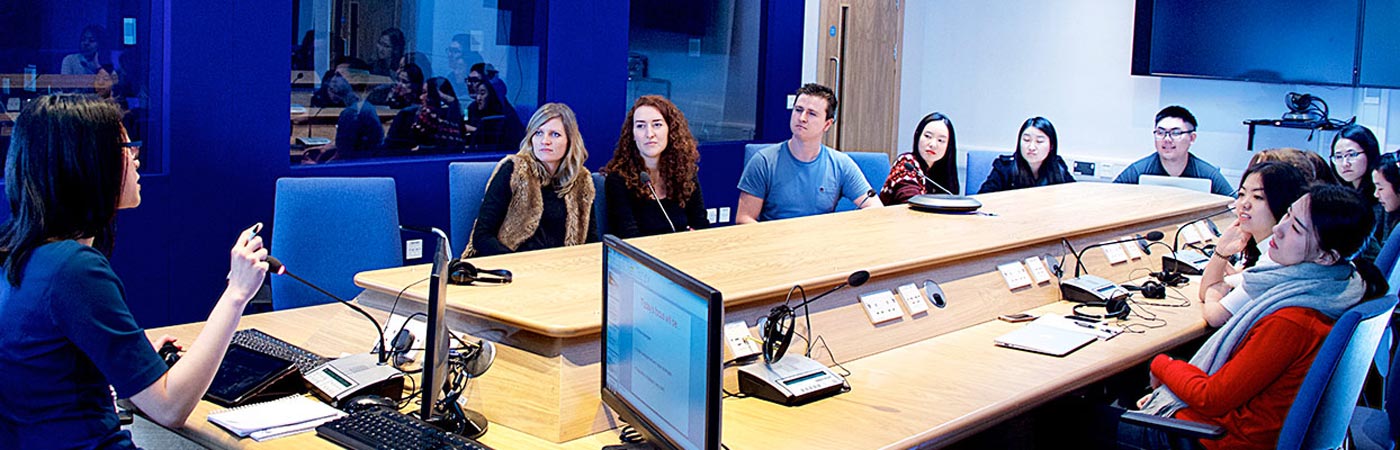 Group of people in room at a desk 