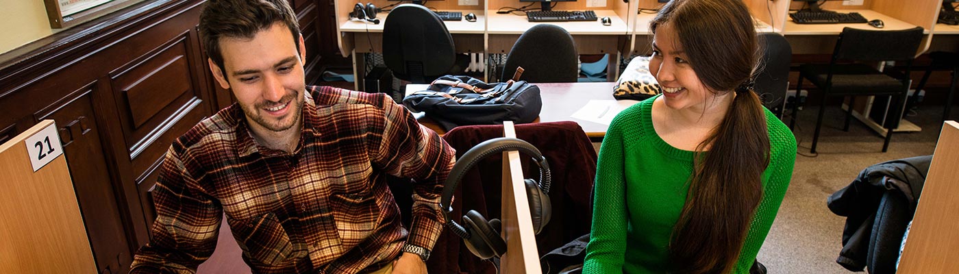 Two students working in booths