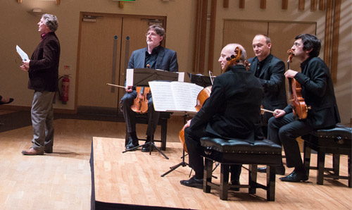 Musicians sat on stage with their instruments