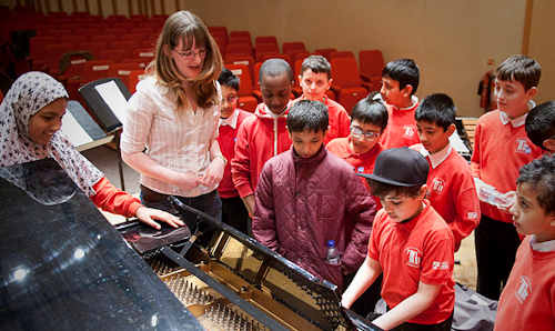 School children playing piano