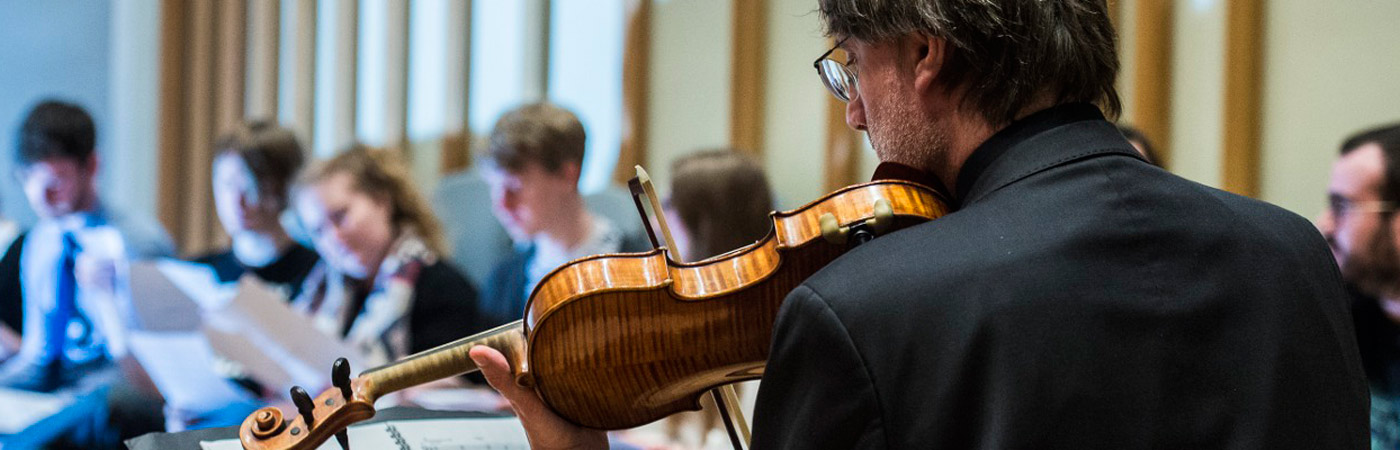 Students watching violinist 