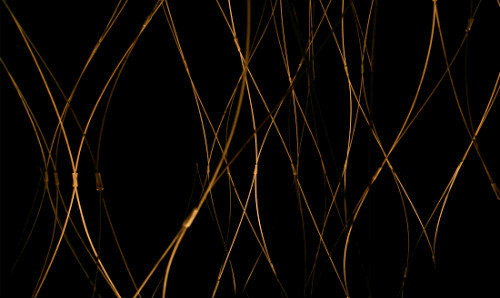 Abstract image of wires - amber on a black background