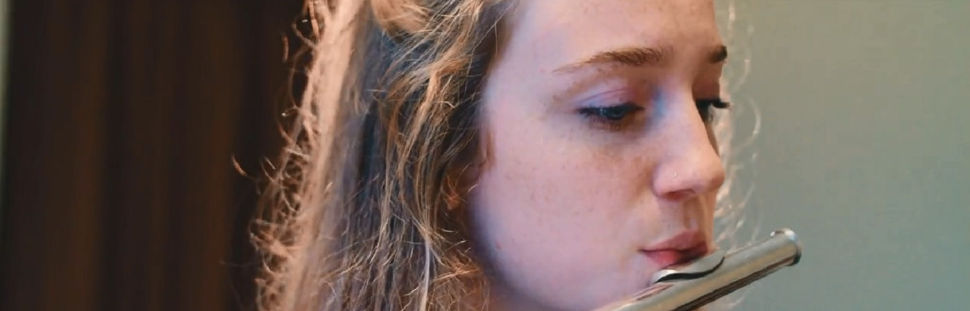 Student playing instrument in rehearsal room