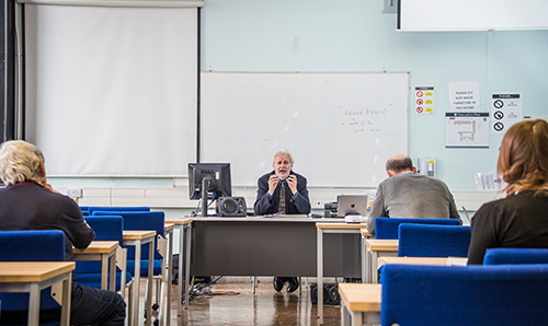 Man teaching seminar in classroom