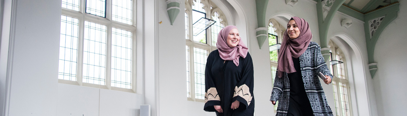 Two religions students walking through a converted church