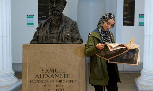 Student reading in Samuel Alexander building