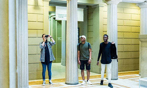 Three undergraduate students exploring Manchester Art Gallery