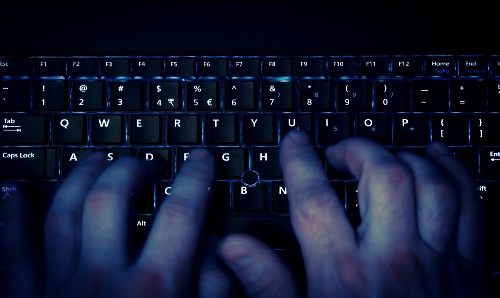 A person typing on a keyboard