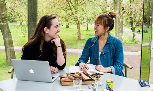 Two students in a cafe