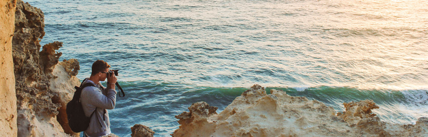 Student taking photo of sea while abroad.