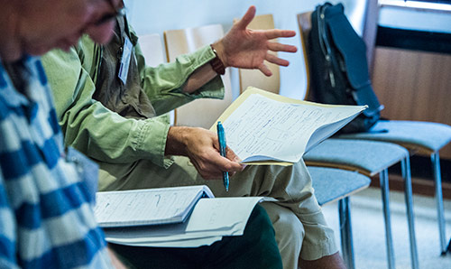 Close up shot of someone working with paper using to hands to articulate what they are saying