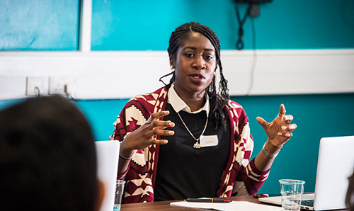 Female with hands open giving a talk